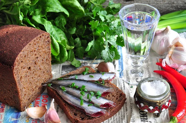 Russian traditions open sandwich with a sardines on rye bread with the wineglass of vodka — Stock Photo, Image