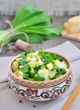 Green chopped eggs salad with potato, ramson and parmesan cheese clipart