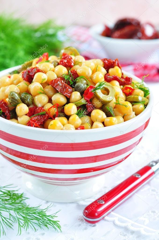 Vegetarian salad with chickpeas, dried tomatoes, capers and dill