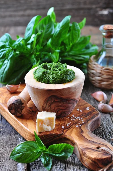 Homemade pesto made of organic basil on the board of olives with parmesan and garlic — Stock Photo, Image