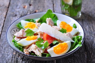 salad with tuna, tomatoes, boiled eggs and parmesan cheese