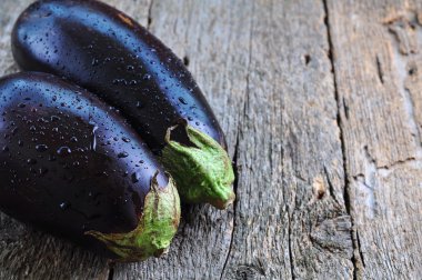 organic eggplants on a wooden background