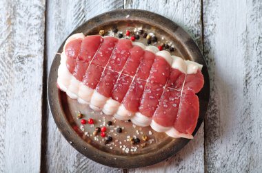 raw roast with spices and sea salt on wooden table