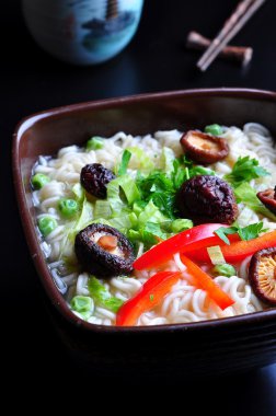 ramen noodles with shiitake mushrooms, green peas, sweet pepper and coriander