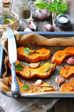 Vegetarian pumpkin baked with olive oil, rosemary, basil and garlic