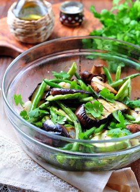 Grilled vegetables - zucchini, eggplant, green beans, onion, mushrooms, garlic and coriander, olive oil, wine vinegar and light soy sauce. Healthy foods.