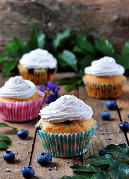 Homemade cupcakes with berries and lavender on a wooden table, rustic style — Stok fotoğraf