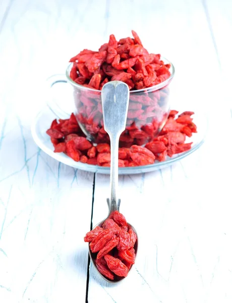 Dried goji berries on a blue and white wooden background — 스톡 사진