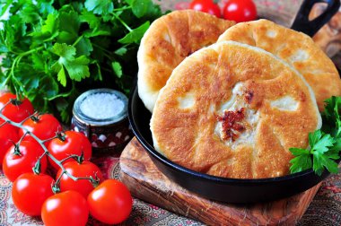 Home belyashi open pies, fried in olive oil with lamb and onions