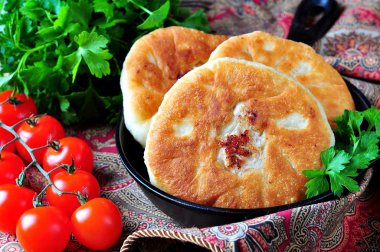 Home belyashi open pies, fried in olive oil with lamb and onions