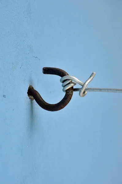 Metal hook on blue wall — Stock Photo, Image