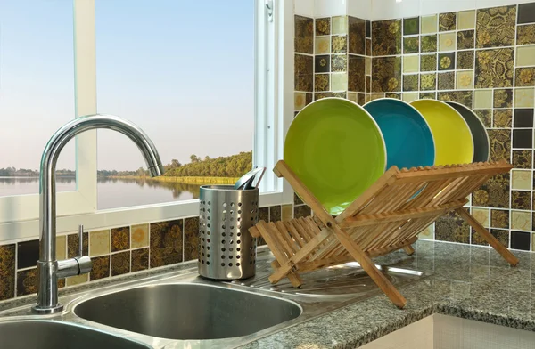 kitchen sink with wooden plate rack