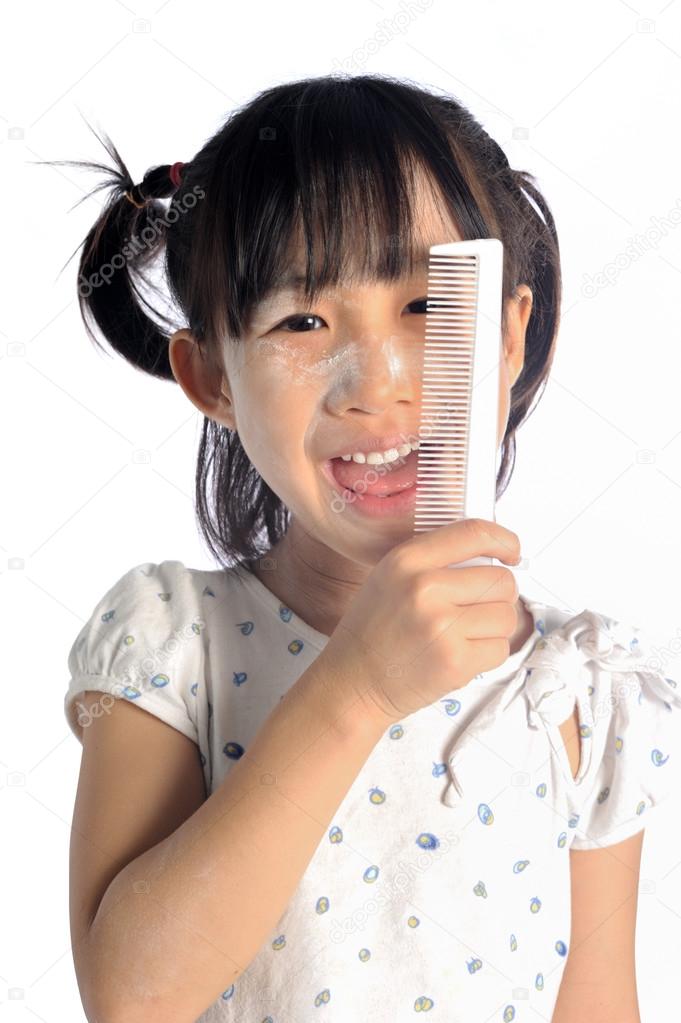 Smiling Asian Little Girl With Applying Make Up Baby Powder On F
