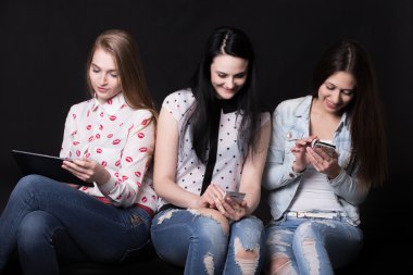 Girlfriends using different devices