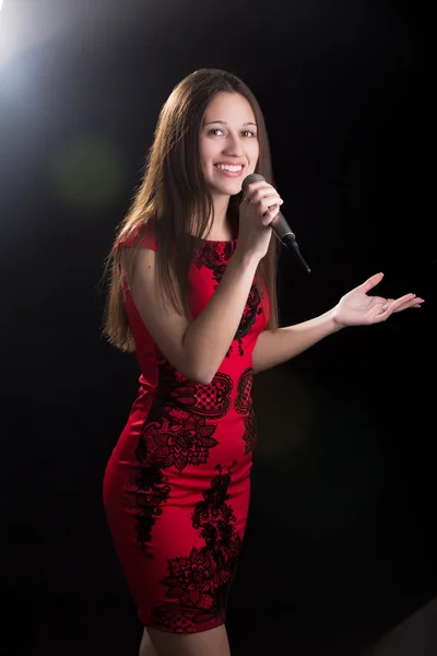 Young female speaker in red dress — Stok fotoğraf