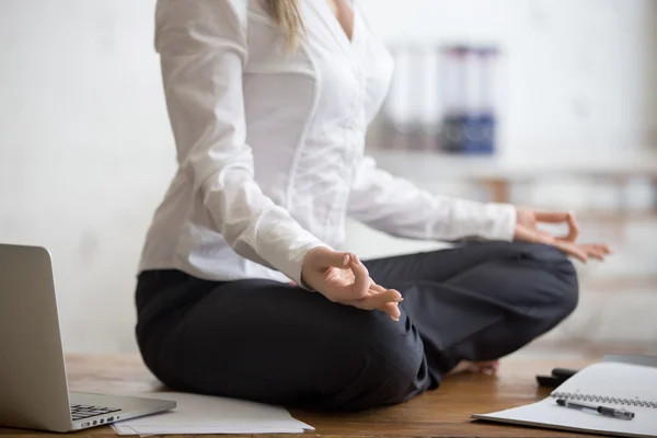 Business woman sitting in lotus pose — Stock Photo, Image