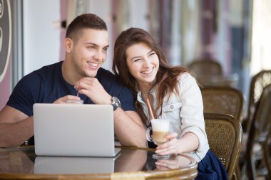 Couple with laptop at a cafe