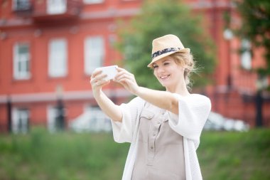 Young traveler woman making selfie during abroad trip