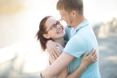 Woman standing in her partners arms
