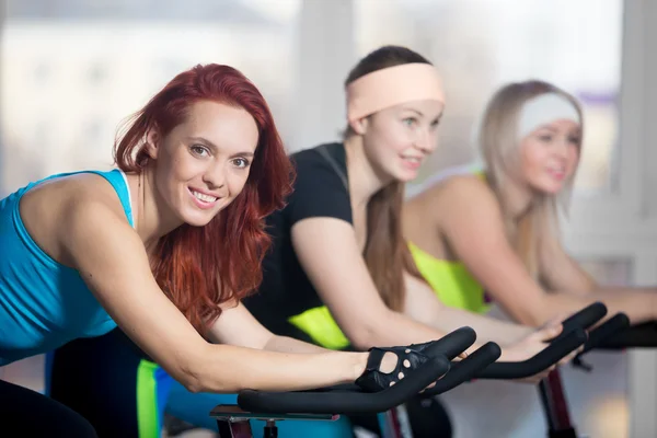 Group of women working out on cycles — Stock Photo, Image