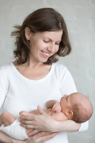 Young mother hugging her newborn child — Stock Photo, Image