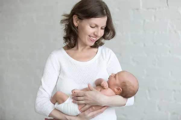 Young mother holding her newborn baby — Stock Photo, Image