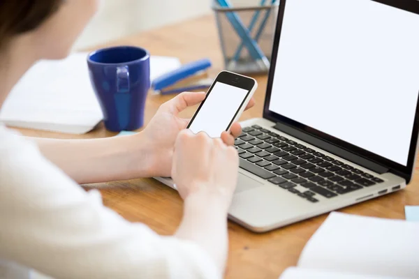 Young office woman synchronizing smartphone and laptop. Close-up — Stock Fotó