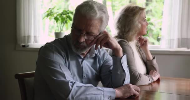 Elderly couple sitting separately thinking about relationship problems feeling frustration — Stock Video