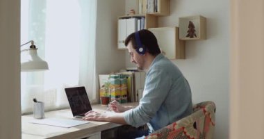 Gülümseyen 30 'lu yaşlardaki genç erkek video konferans çağrısı yapıyor..