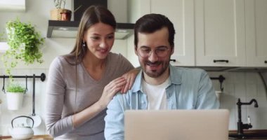 Mutlu eşler favori takımı destekliyor, bilgisayarda spor maçı izliyorlar..