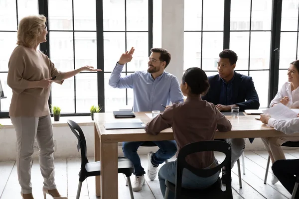 Motivated male employee raise hand at meeting with CEO — Stock Photo, Image