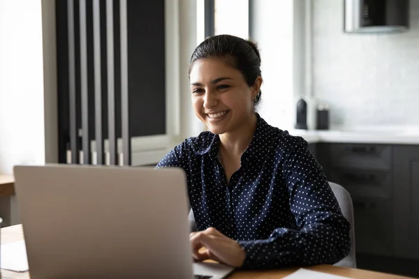 Smiling Indian female work on laptop in office — Stock Photo, Image