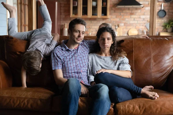 Unhappy parents distressed by ill-behaved active son — Stock Photo, Image