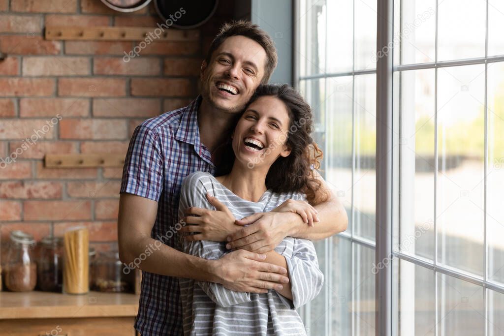 Portrait of smiling Caucasian couple enjoy weekend at home
