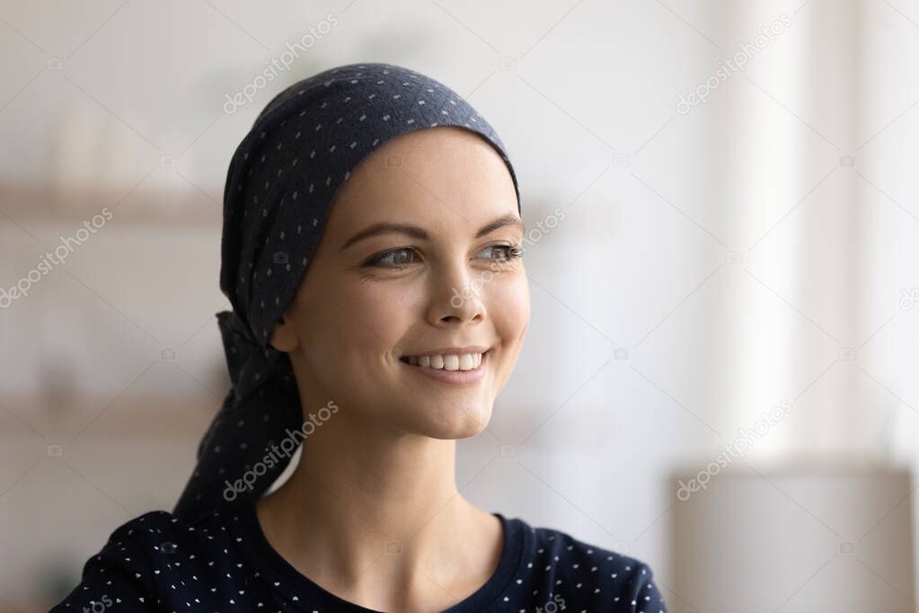 Head shot portrait smiling dreamy young woman wearing scarf