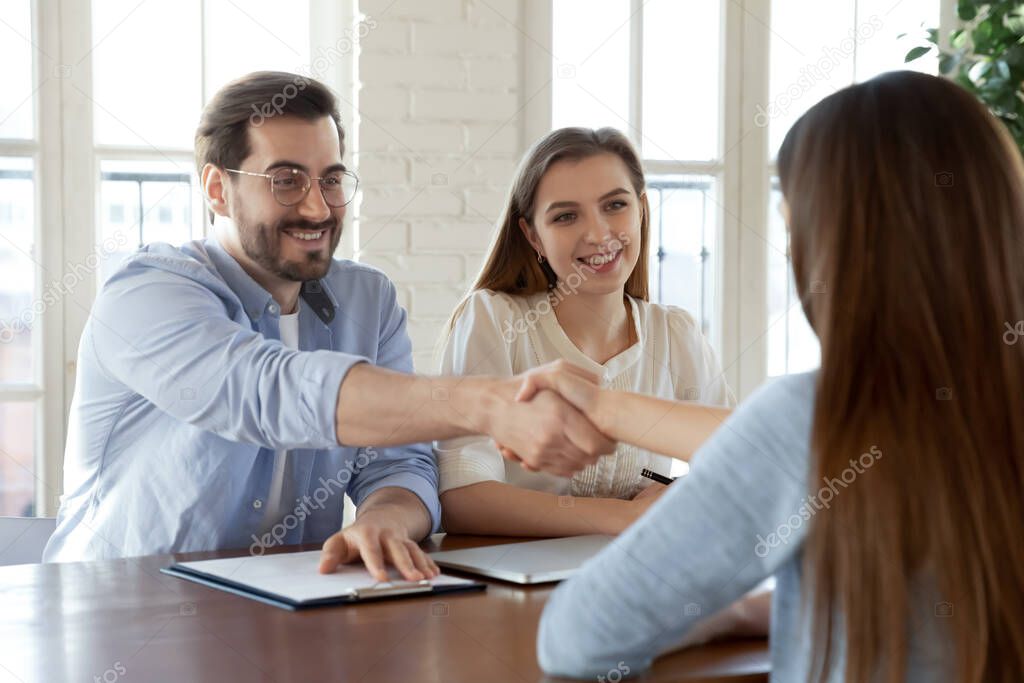 Man and woman hr greeting new team member with handshaking