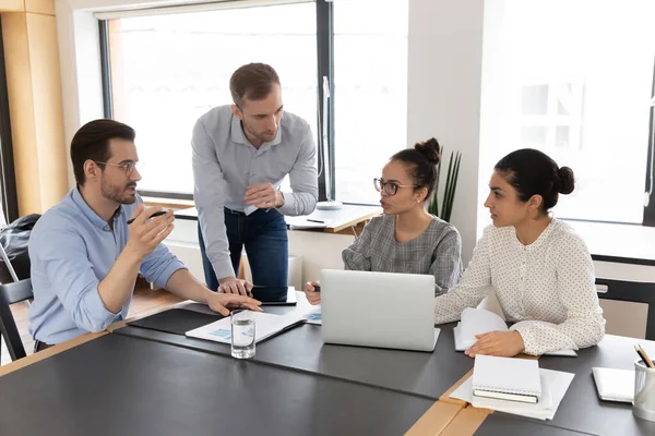 Concentrated young multiracial diverse colleagues brainstorming in office. — Stock Photo, Image