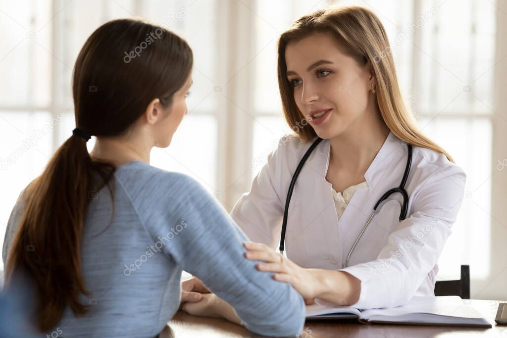Understanding caring female doctor supporting worried anxious young woman patient