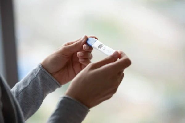 Close up of woman hands holding positive home pregnancy test — Stock Photo, Image