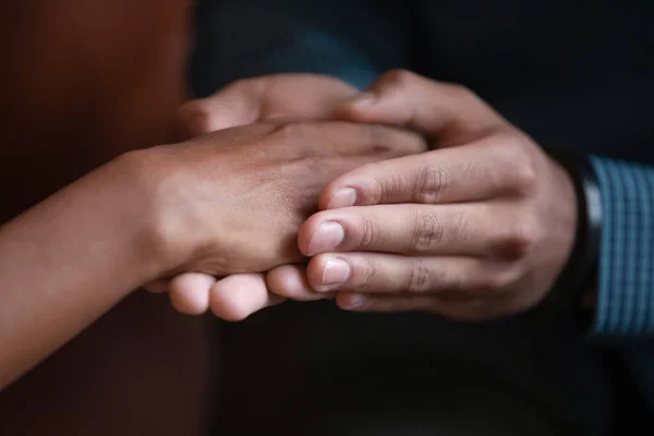 Mannelijke handen bedekken palm van gemengde ras vrouwelijke expressie zorg — Stockfoto