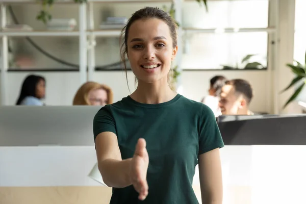 Pleasant millennial woman hr stretching hand inviting new team member — Stock Photo, Image