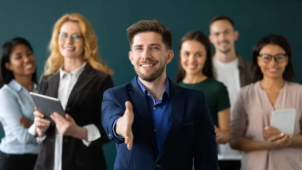 Positive confident male hr extending hand greeting new staff member — Stock Photo, Image