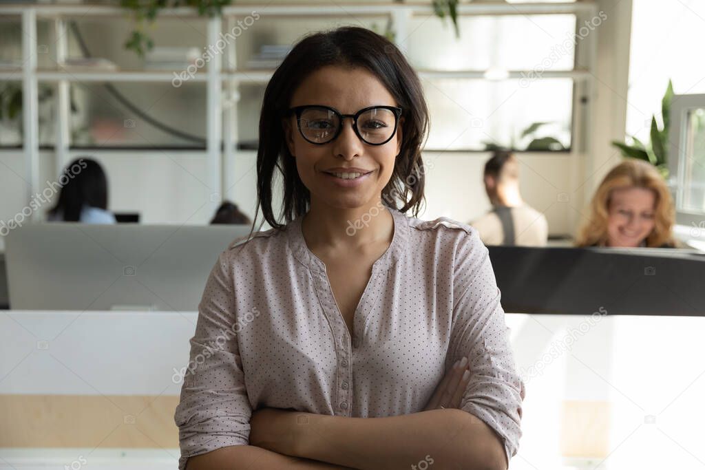 Confident biracial female executive looking at camera with happy smile