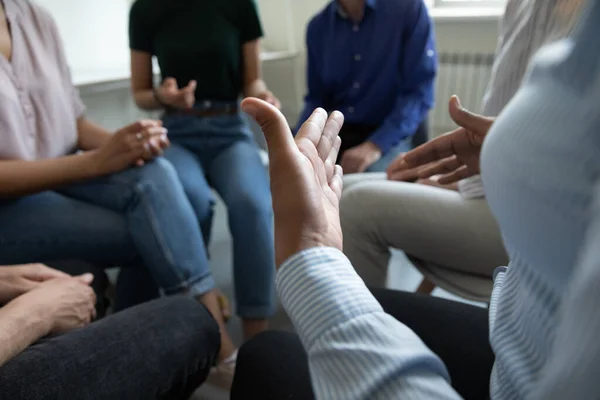 Diverse people gathered in circle discussing work or self problems