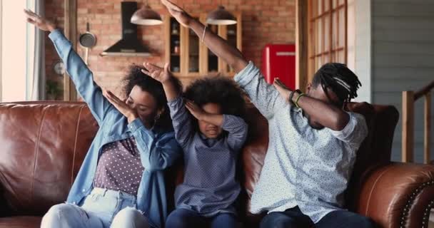 Glad afrikansk familj dabbing sittande på soffan hemma — Stockvideo