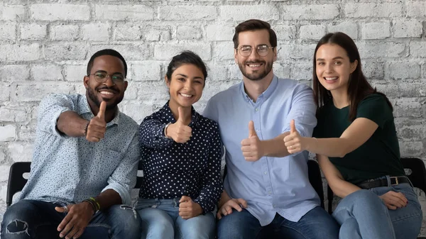 Four multiethnic persons job seekers showing thumbs up being hired — Stock Photo, Image