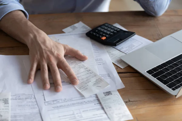 On desk lot of receipts calculator and laptop closeup view — Stock Photo, Image