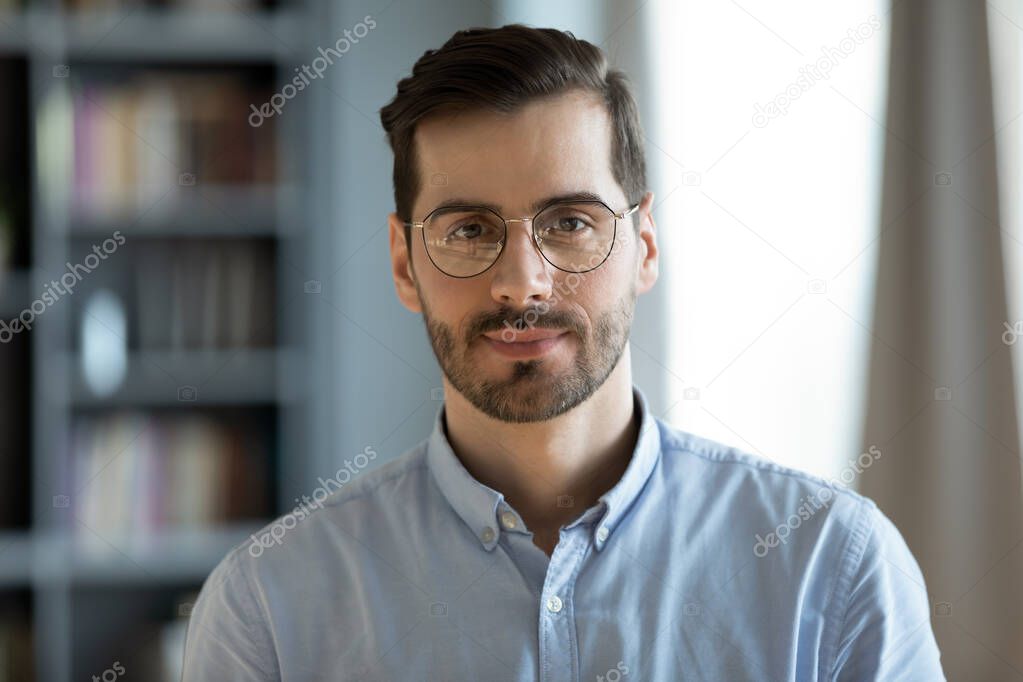 Headshot portrait businessman standing in modern office pose for camera