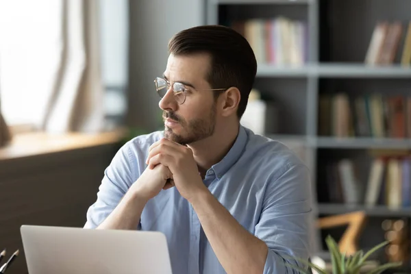 Pensive businessman distracted from computer work looking in distance thinking — Stock Photo, Image