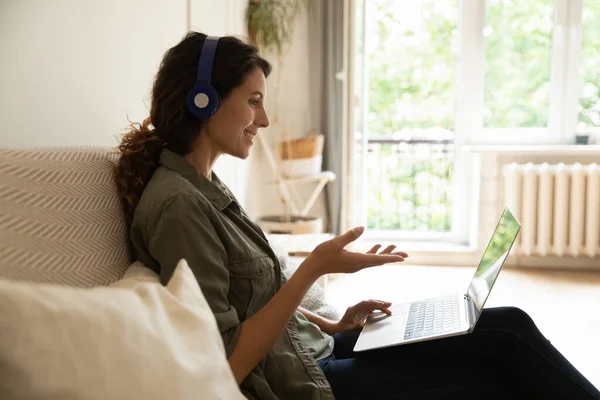 Millennial woman in headphones talk on video call